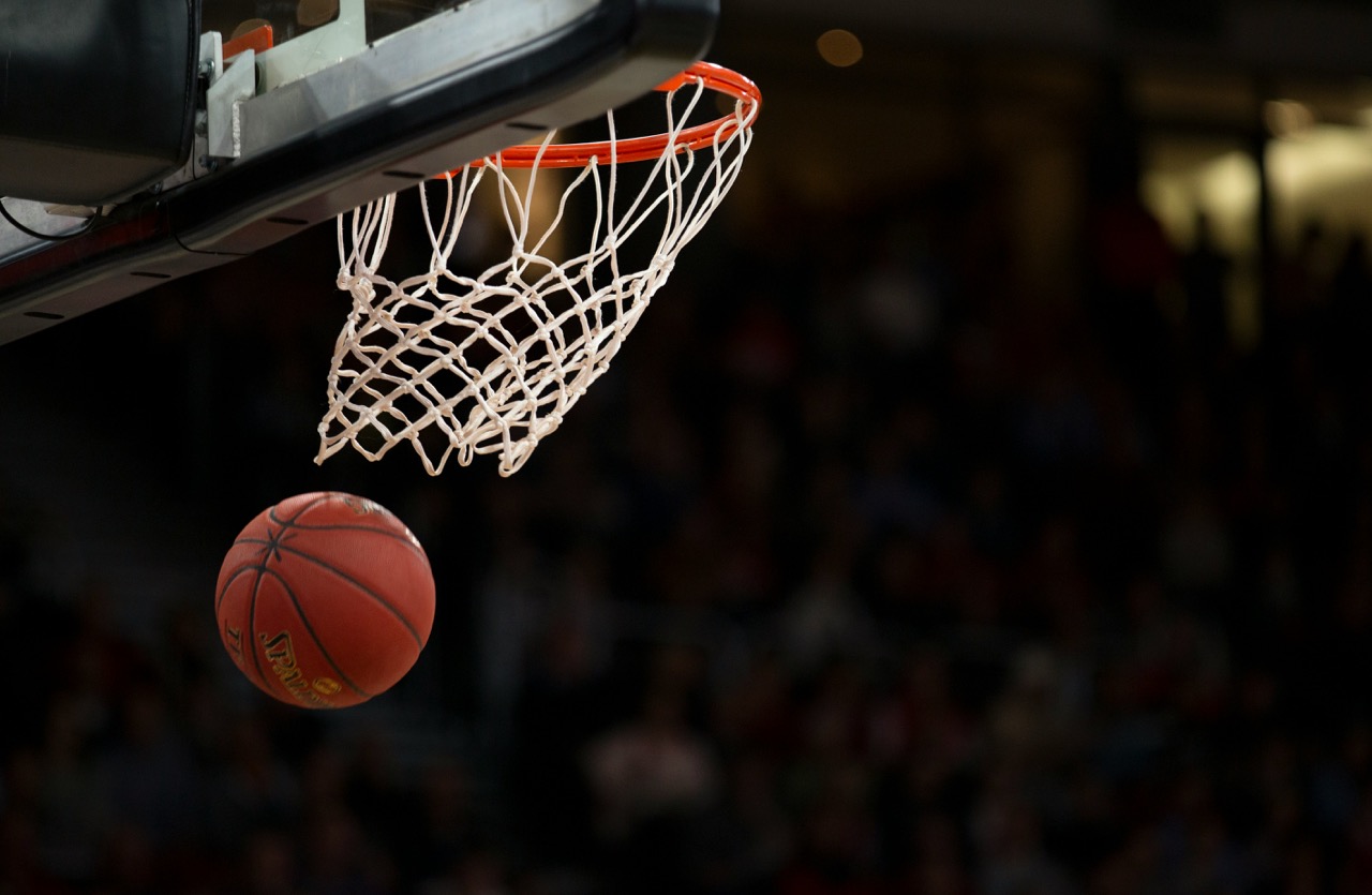Basketball dropping through the hoop mid-game