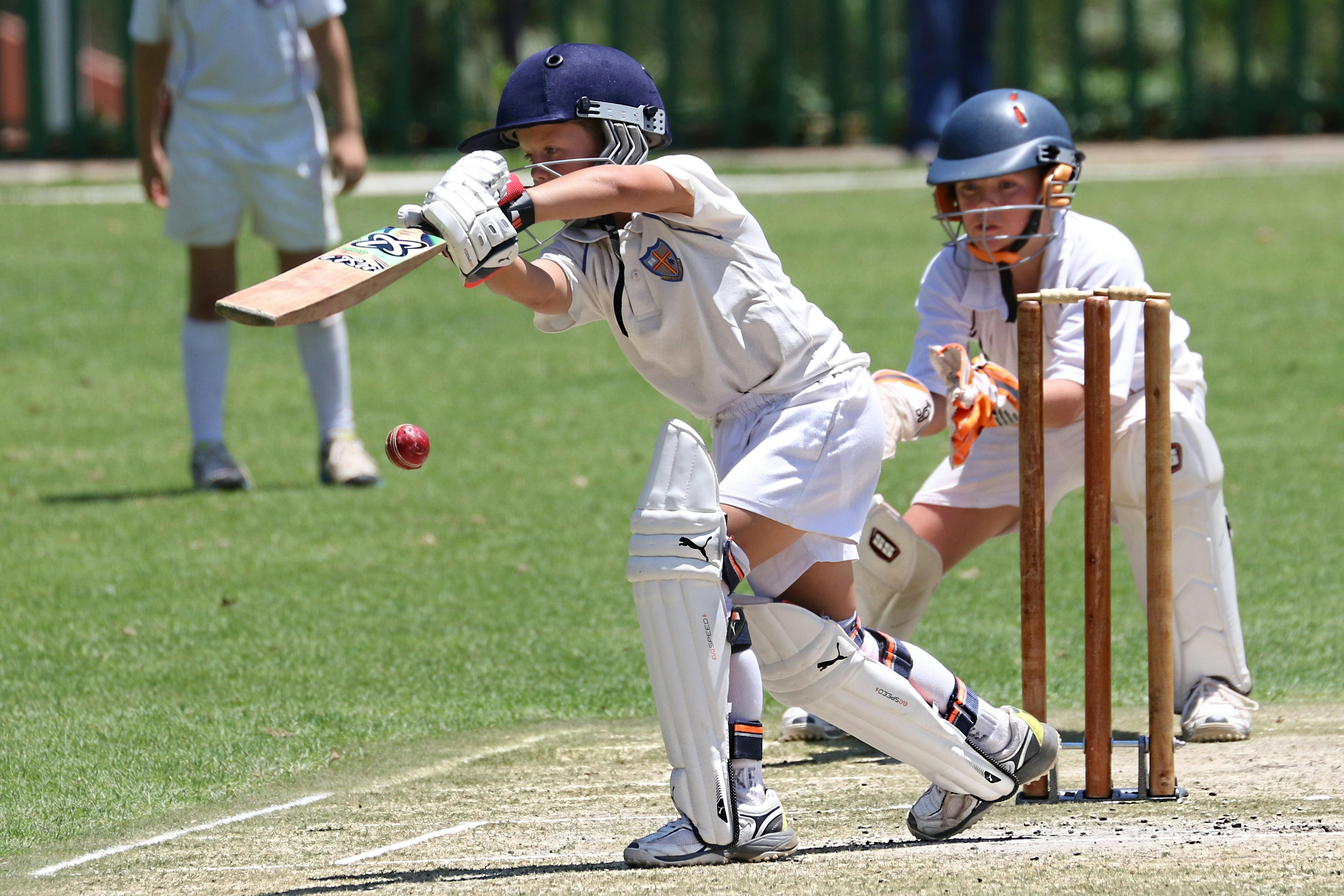 Junior batter playing a shot during a cricket match