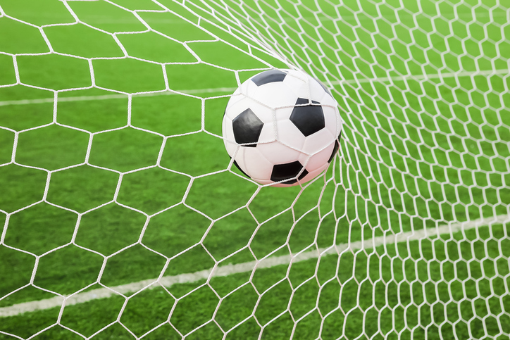 Soccer ball hitting the back of the net
